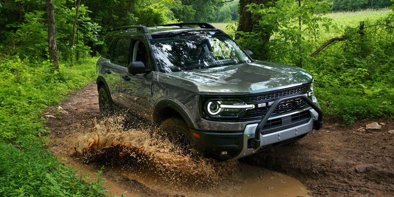 Green Ford Bronco Sport splashing through mud