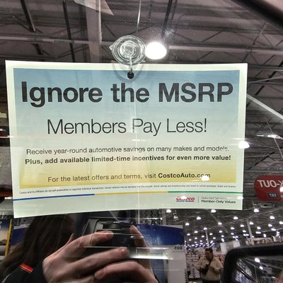 Costco Auto Program sign reading Ignore the MSRP, Members Pay Less