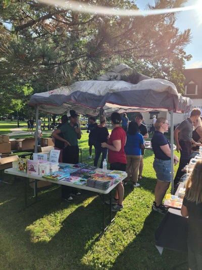 Kids and parents sharing books together at Storytime in the Park