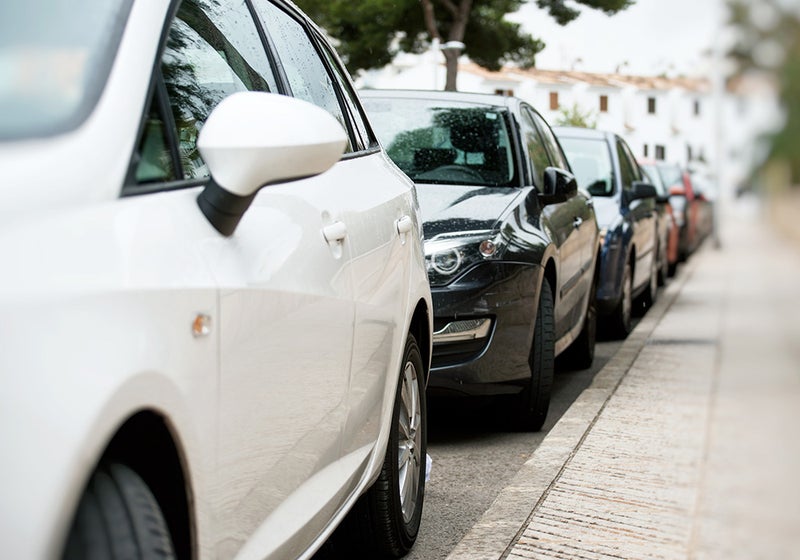 A row of new vehicles lined up and ready for delivery on a dealership lot